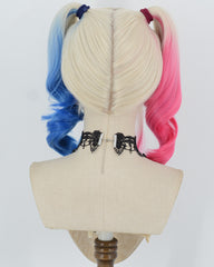 A wig displayed on a fabric mannequin head, viewed from the back. The wig has a center part with two pigtails: one side is light blue, the other is pink
